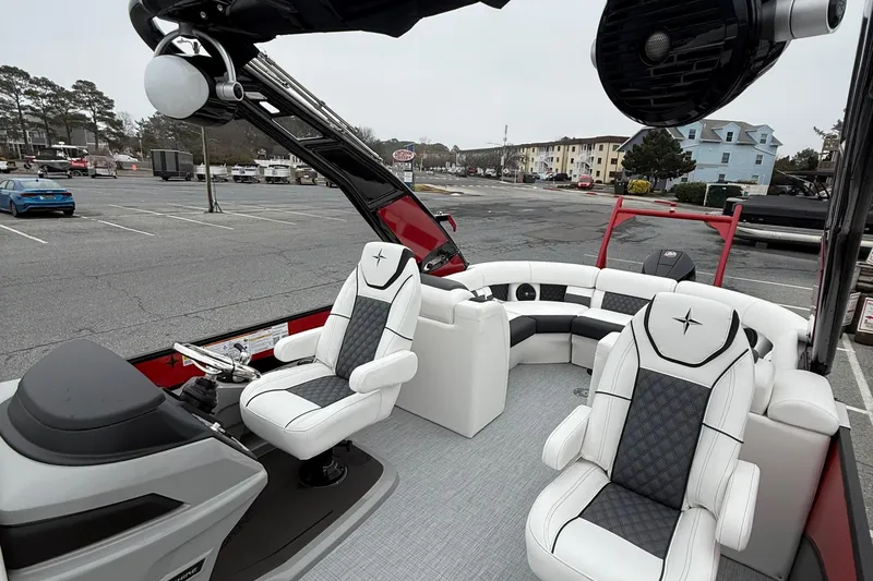 Slide: The Image of 2026 Berkshire 23RFX STS pontoon boat with luxurious seating in a parking lot. - 10