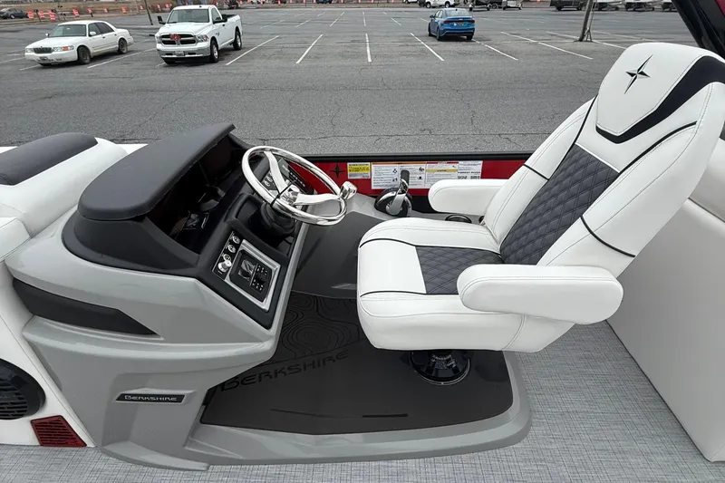 Slide: The Image of 2026 Berkshire 23RFX STS boat interior with luxurious captain's chair and sleek dashboard design. - 13
