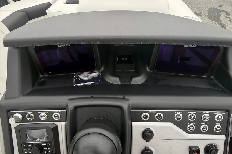 Slide: The Image of Dashboard of 2026 Berkshire 23RFX STS boat with Simrad displays and control panel. - 14