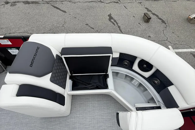 Slide: The Image of 2026 Berkshire 23RFX STS boat interior with white and black seating and storage compartment. - 18
