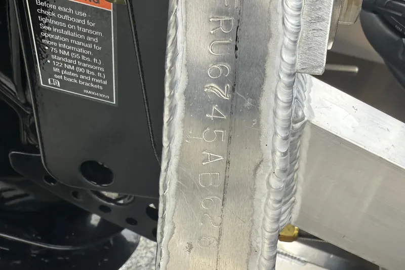 Slide: The Image of Close-up of a 2026 Berkshire 23RFX STS boat's metal component with engraved serial number. - 21