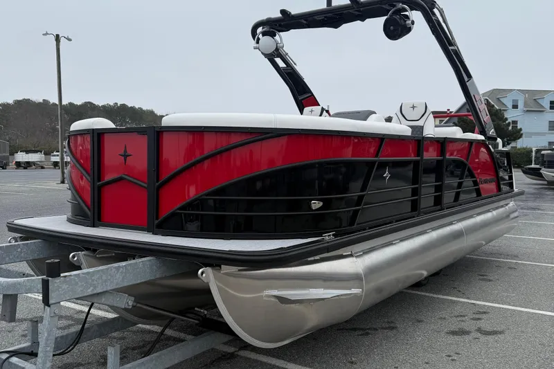 Slide: The Image of 2026 Berkshire 23RFX STS pontoon boat with red and black design on a trailer. - 4