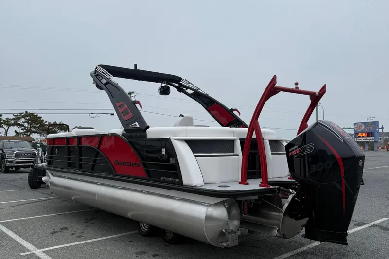 Slide: The Image of 2026 Berkshire 23RFX STS pontoon boat with powerful outboard motor in parking lot. - 6