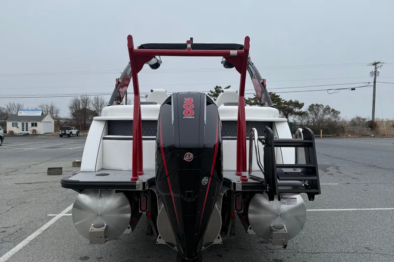 Slide: The Image of 2026 Berkshire 23RFX STS boat with powerful outboard motor in a parking lot. - 7