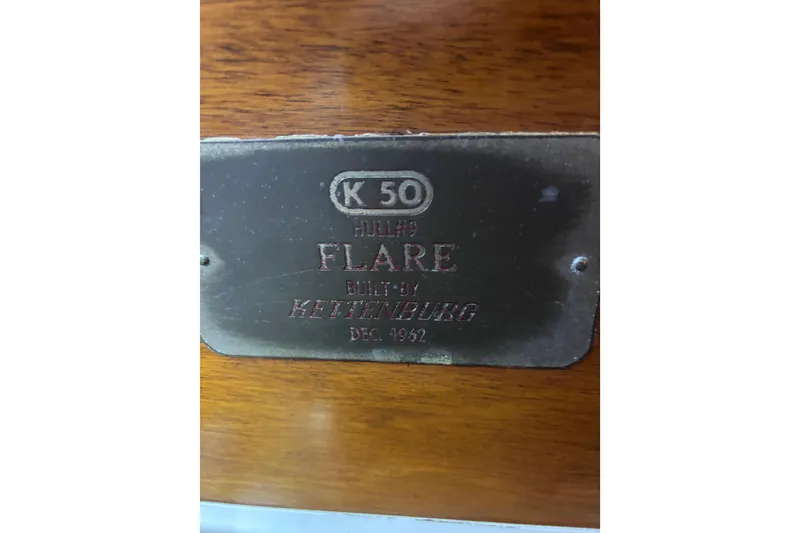 Slide: The Image of 1962 Kettenburg Sloop interior cabin with bed and bathroom. - 10