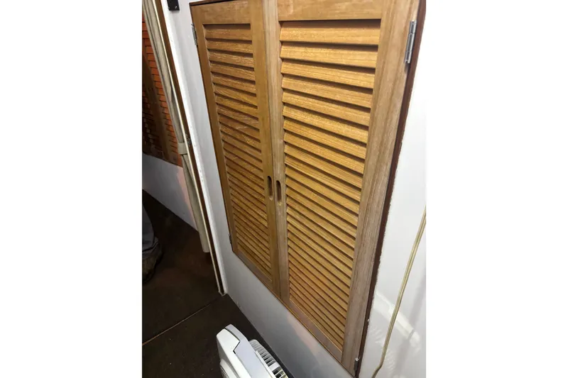 Slide: The Image of 1962 Kettenburg Sloop interior sink area with countertop and storage cabinets. - 11