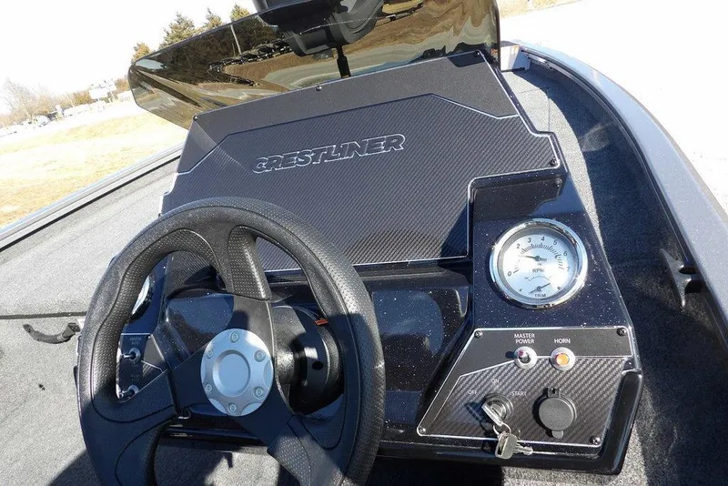 Slide: The Image of 2026 Crestliner XF 189 boat dashboard with steering wheel and RPM gauge. - 22