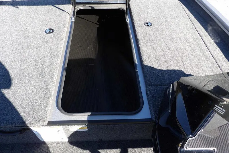 Slide: The Image of 2026 Crestliner XF 189 boat storage compartment with open lid, showcasing spacious interior. - 23