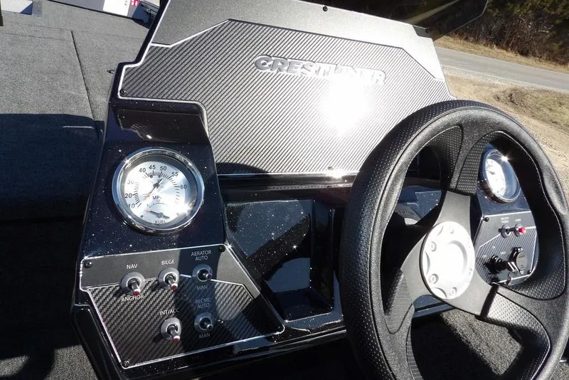 Slide: The Image of 2026 Crestliner XF 189 boat dashboard with steering wheel and gauges. - 27