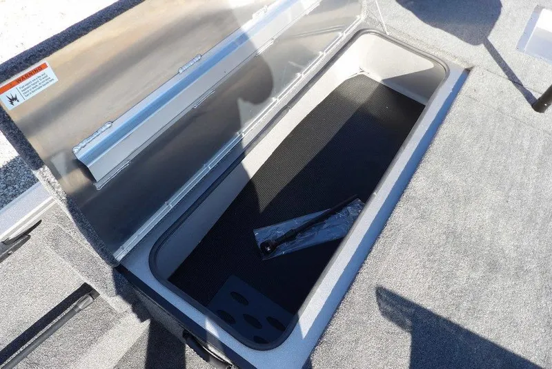 Slide: The Image of Open storage compartment in 2026 Crestliner XF 189 boat, featuring carpeted interior. - 29