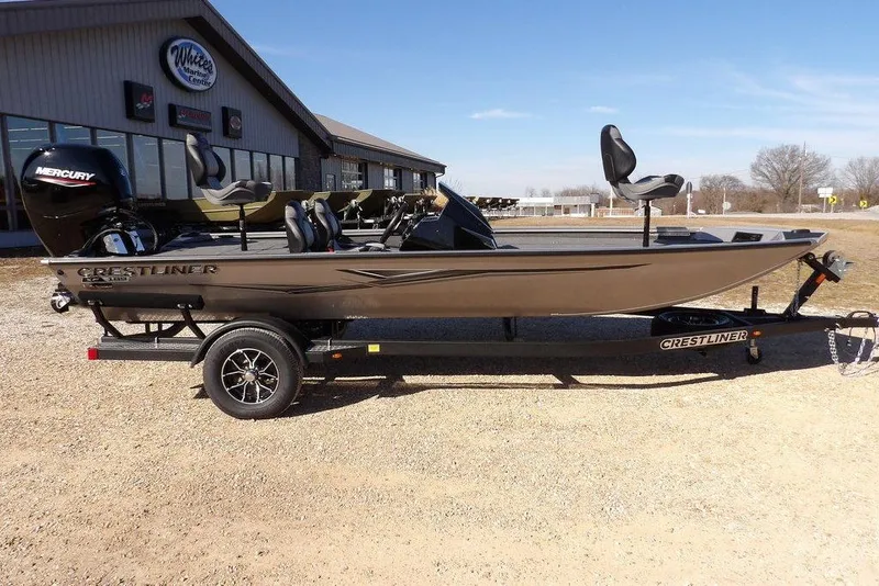 Slide: The Image of 2026 Crestliner XF 189 fishing boat on trailer, parked outside marine center. - 3