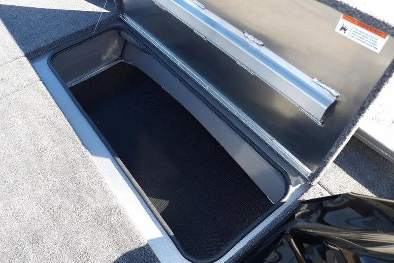 Slide: The Image of Open storage compartment in 2026 Crestliner XF 189 boat, featuring carpeted interior. - 32