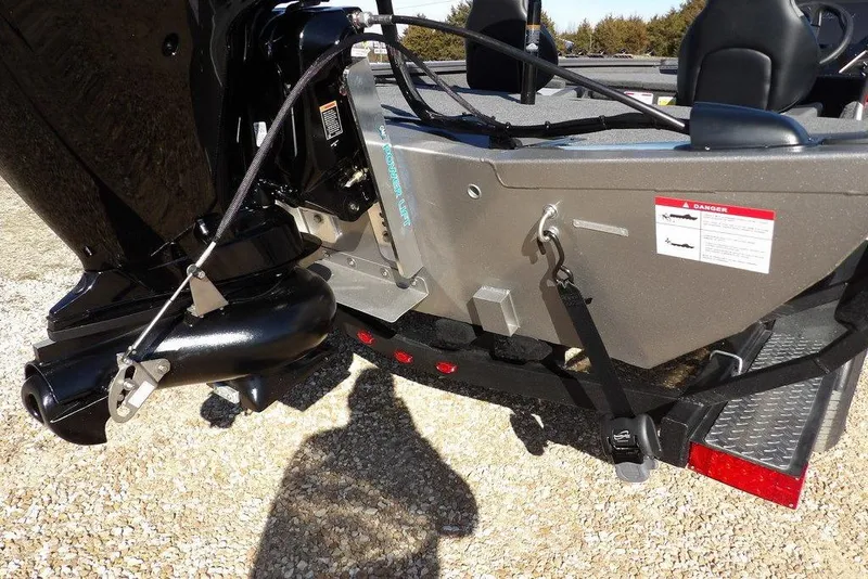 Slide: The Image of 2026 Crestliner XF 189 boat rear view with motor and safety warning label. - 34