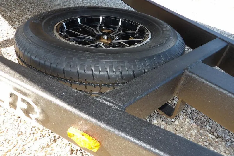 Slide: The Image of 2026 Crestliner XF 189 trailer tire on gravel surface. - 35