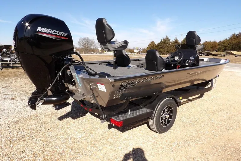 Slide: The Image of 2026 Crestliner XF 189 boat with Mercury engine on a trailer, parked outdoors. - 5