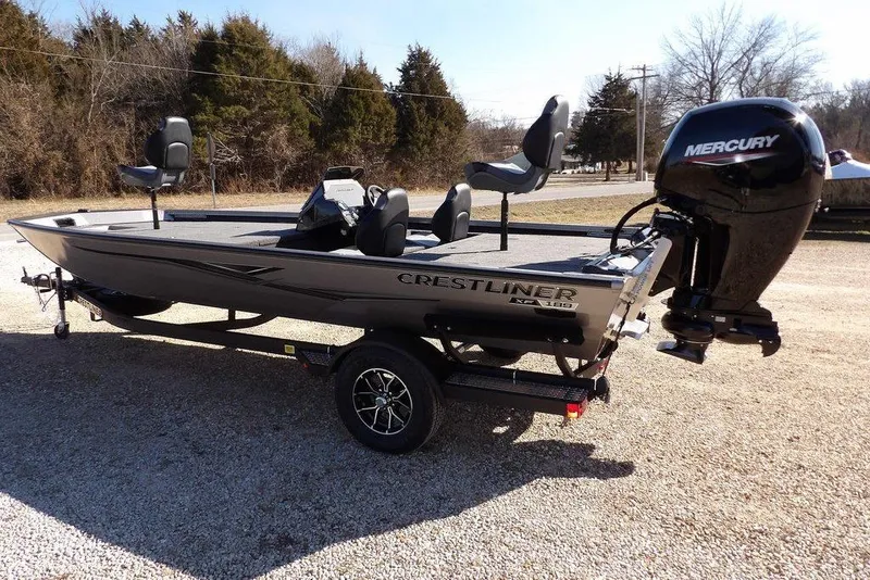 Slide: The Image of 2026 Crestliner XF 189 boat with Mercury engine on a trailer, parked outdoors. - 7