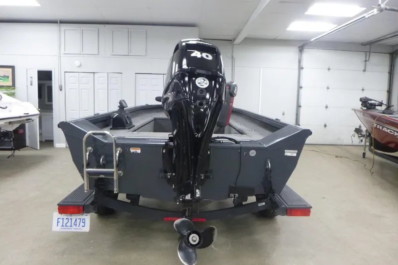 Slide: The Image of 2021 Ranger VS1660 T boat with 40 HP motor in a garage setting. - 3