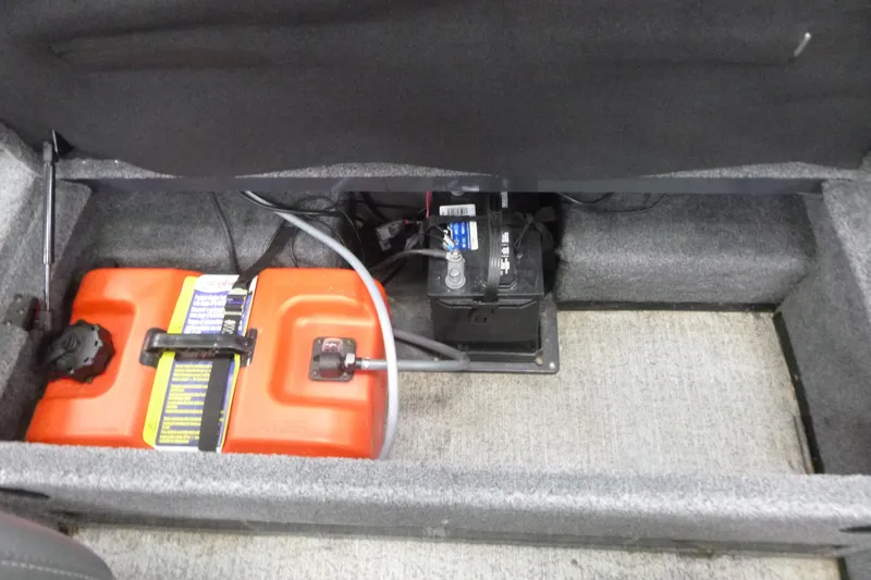 Slide: The Image of 2021 Ranger VS1660 T storage compartment with battery and orange fuel tank. - 9