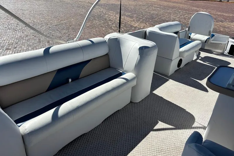 Slide: The Image of 2004 Crest 2100 boat interior with white and blue seating arrangement. - 14