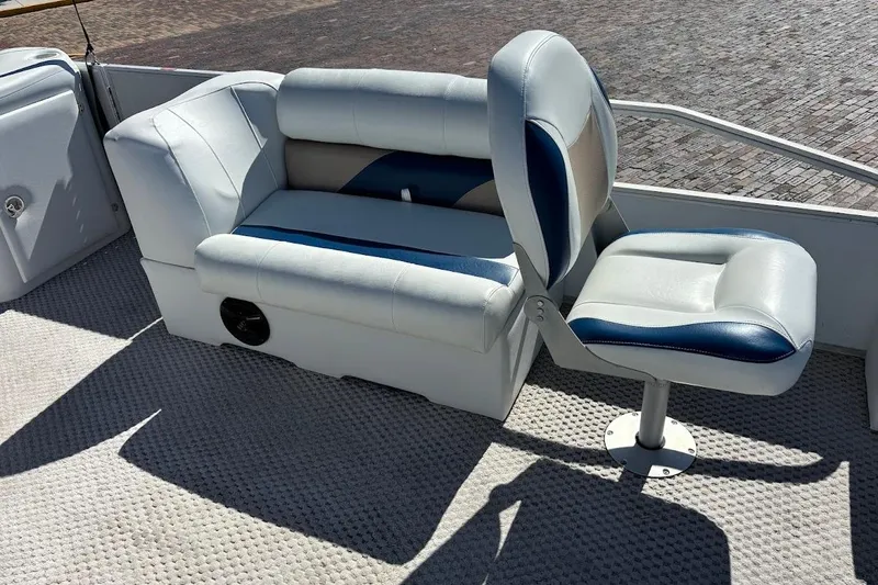 Slide: The Image of Crest 2100 2004 boat interior with cushioned seating and carpeted floor. - 19
