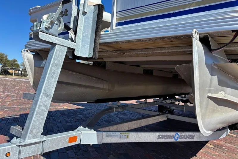 Slide: The Image of 2004 Crest 2100 pontoon boat on Shore Haven trailer, close-up view. - 4