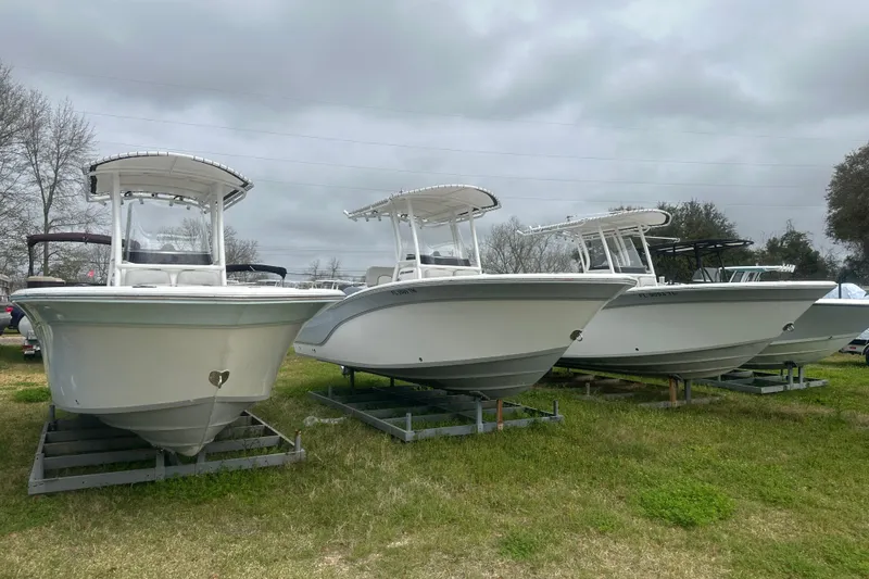 The Image of 2023 Sea Fox 228 Commander boats displayed outdoors on grassy area. - 1
