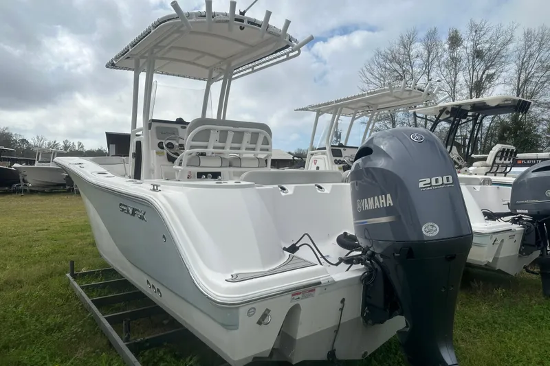 Slide: The Image of 2023 Sea Fox 228 Commander boat with Yamaha 200 engine, displayed outdoors. - 10