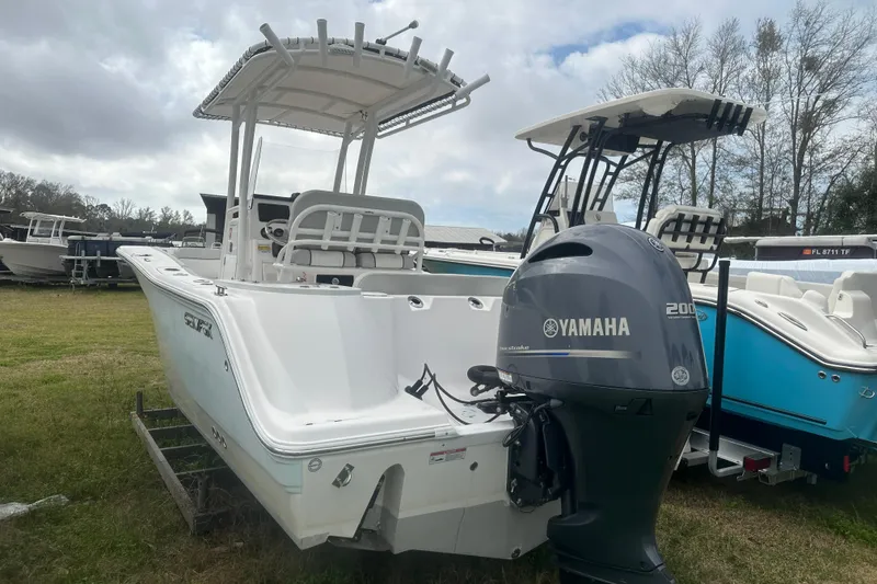Slide: The Image of 2023 Sea Fox 228 Commander boat with Yamaha 200 engine, parked on grass. - 12