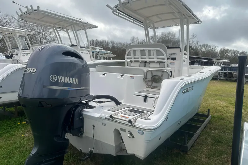 Slide: The Image of 2023 Sea Fox 228 Commander boat with Yamaha 200 engine, parked on grass. - 13