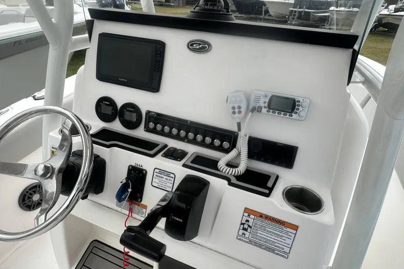 Slide: The Image of 2023 Sea Fox 228 Commander boat dashboard with steering wheel and navigation controls. - 15
