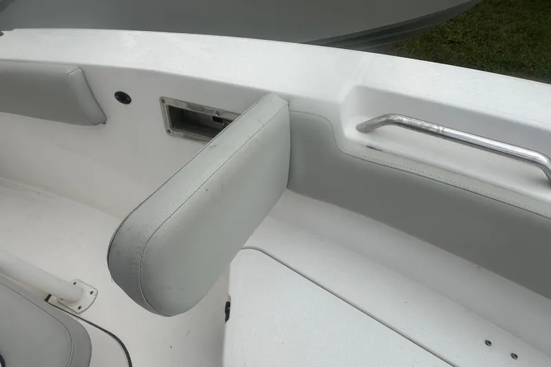 Slide: The Image of 2023 Sea Fox 228 Commander boat interior with cushioned seating and metal handrail. - 17