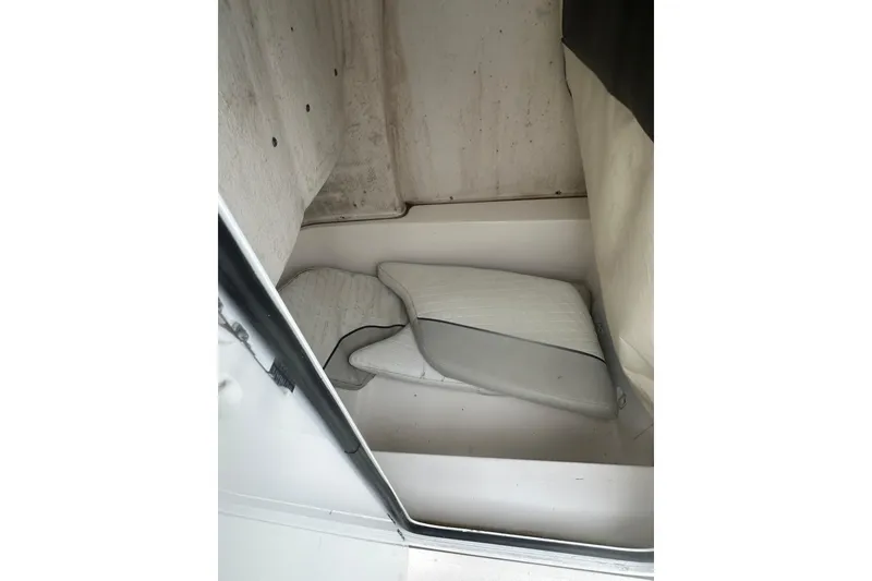 Slide: The Image of 2023 Sea Fox 228 Commander interior cabin with cushions, showcasing compact storage space. - 19