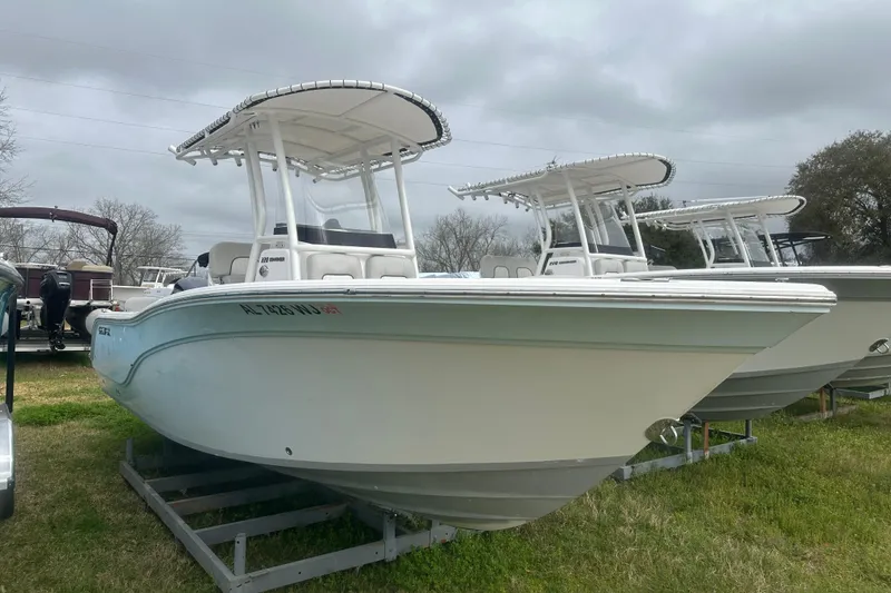 Slide: The Image of 2023 Sea Fox 228 Commander boat displayed outdoors on a grassy area. - 2