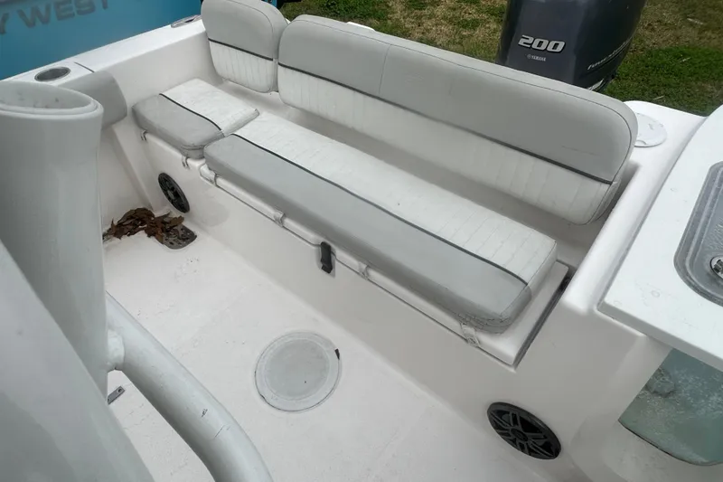 Slide: The Image of 2023 Sea Fox 228 Commander boat interior with cushioned seating and Yamaha 200 engine. - 20