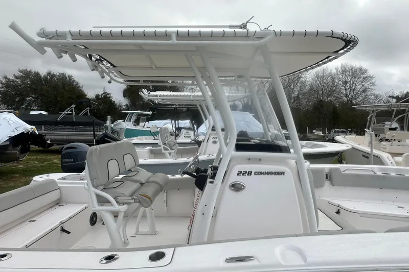 Slide: The Image of 2023 Sea Fox 228 Commander boat with T-top and seating, displayed outdoors. - 24
