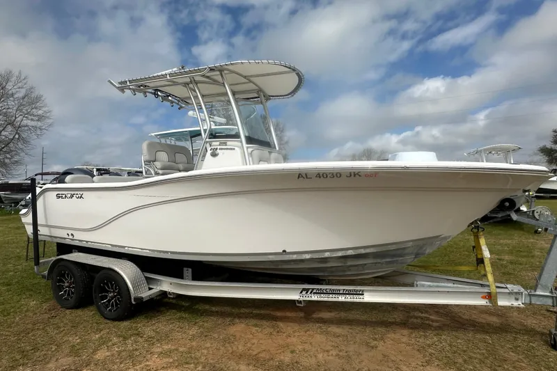 Slide: The Image of 2023 Sea Fox 228 Commander boat on trailer under cloudy sky. - 26