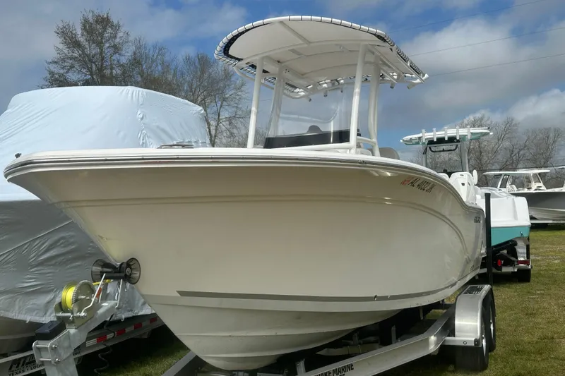 Slide: The Image of 2023 Sea Fox 228 Commander boat on trailer, parked outdoors under cloudy sky. - 28