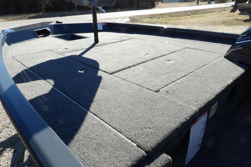 Slide: The Image of 2026 Crestliner XFC 189 boat deck with carpeted surface and storage compartments. - 13