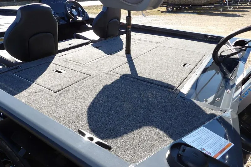 Slide: The Image of 2026 Crestliner XFC 189 boat interior with spacious carpeted deck and seating. - 14