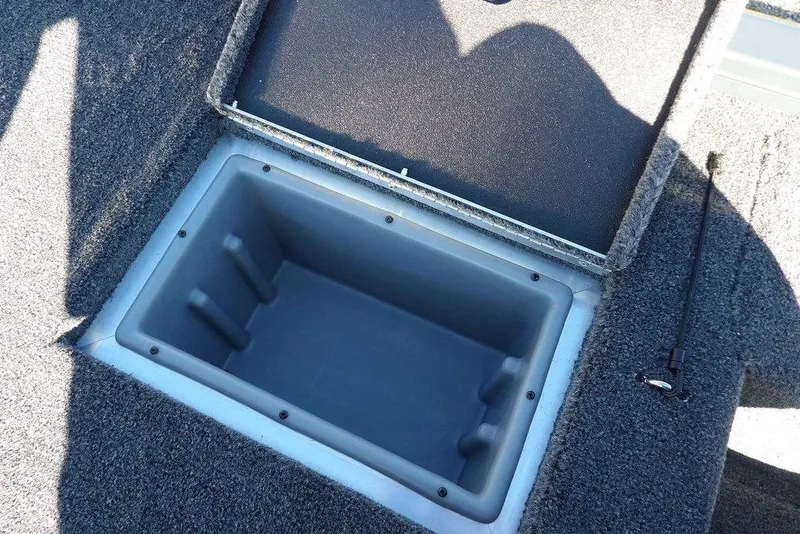 Slide: The Image of Open storage compartment on 2026 Crestliner XFC 189 boat, featuring carpeted interior. - 20