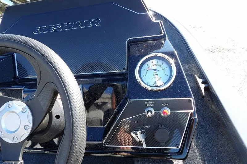 Slide: The Image of 2026 Crestliner XFC 189 boat dashboard with steering wheel and RPM gauge. - 21
