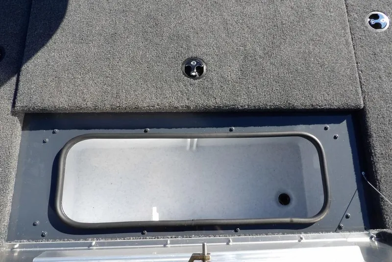 Slide: The Image of 2026 Crestliner XFC 189 boat deck with storage compartment and carpeted surface. - 29