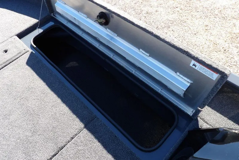 Slide: The Image of 2026 Crestliner XFC 189 boat storage compartment with open lid, showcasing interior space. - 30