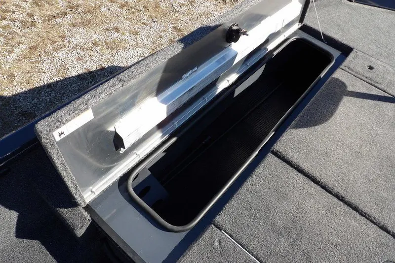 Slide: The Image of 2026 Crestliner XFC 189 boat storage compartment with open lid, showcasing spacious interior. - 31