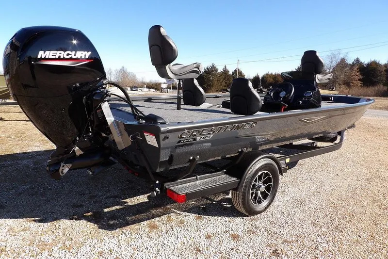 Slide: The Image of 2026 Crestliner XFC 189 fishing boat with Mercury engine on trailer, parked outdoors. - 8