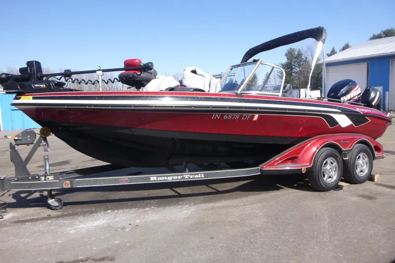The Image of 2008 Ranger 620 VS boat on trailer, red and black design, parked outdoors. - 1