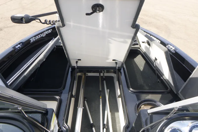 Slide: The Image of 2008 Ranger 620 VS boat interior with open storage compartments and fishing rod holders. - 11