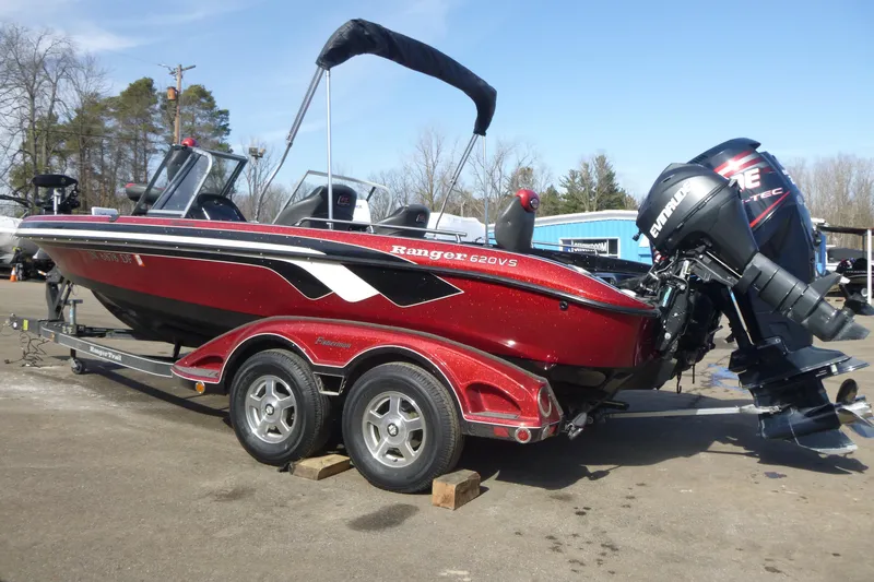 Slide: The Image of 2008 Ranger 620 VS boat on trailer with Evinrude motor, parked outdoors. - 3