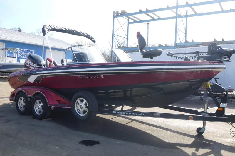Slide: The Image of 2008 Ranger 620 VS boat on trailer, red and black, parked outdoors. - 5