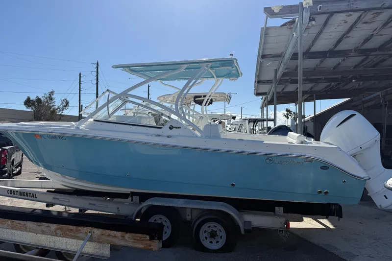 Slide: The Image of 2017 Edgewater 248CX Crossover boat on trailer under a canopy. - 3